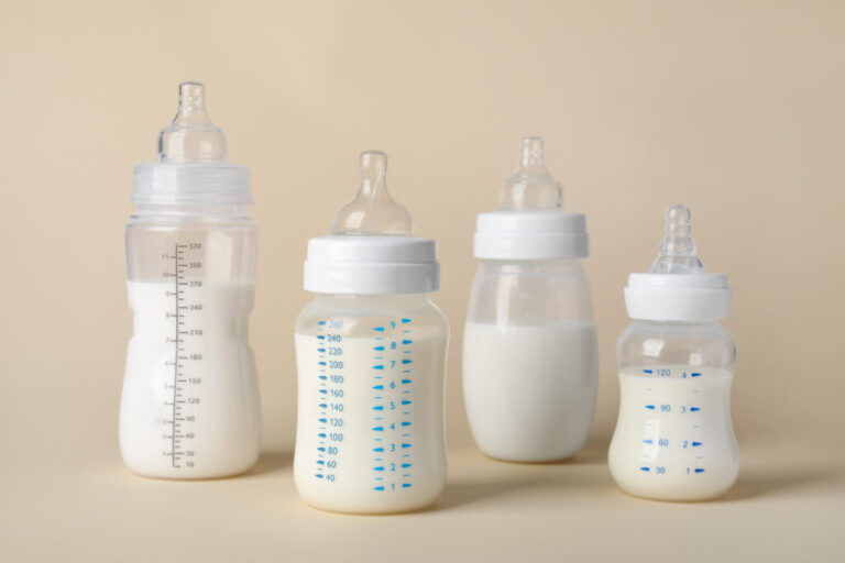feeding-bottles-with-baby-formula-beige-background-1024x683-1