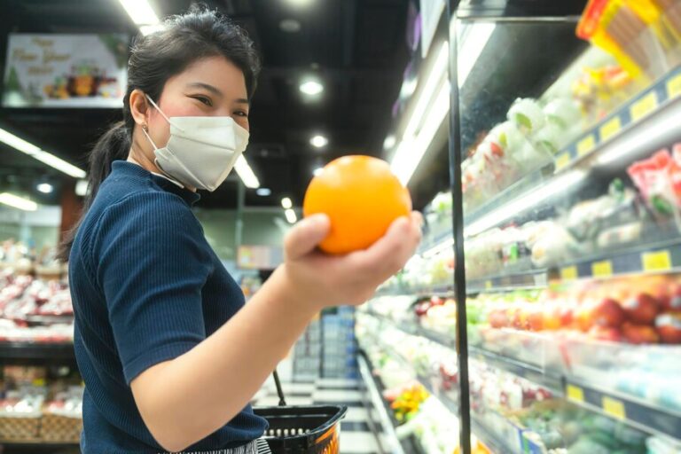 new-normal-after-covid-epidemic-young-smart-asian-female-shopping-new-lifestyle-supermarket-with-face-shild-mask-protection-hand-choose-consumer-products-new-normal-lifestyle_609648-1517