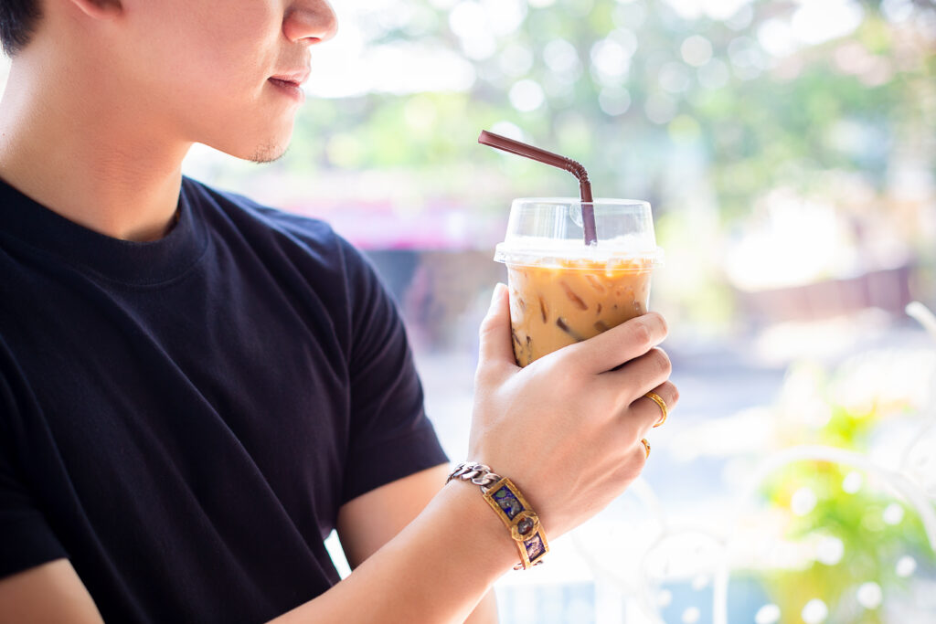 Young man with iced coffee
